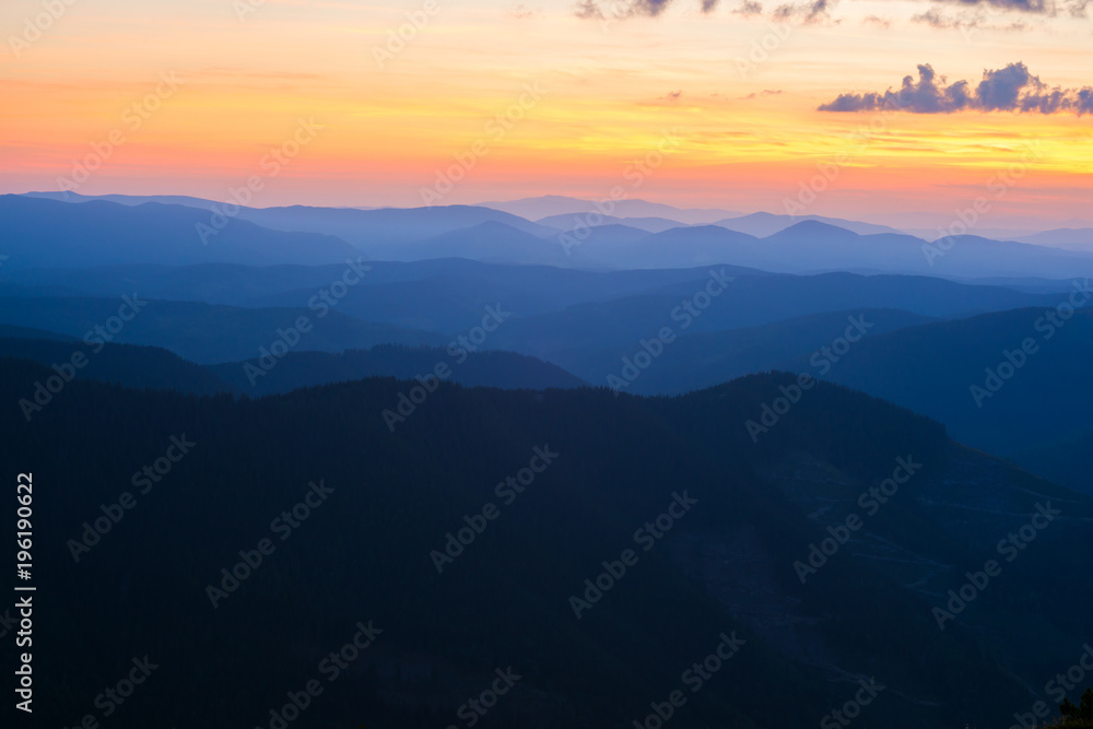 Colorful sky above the mountain ridges during sunset