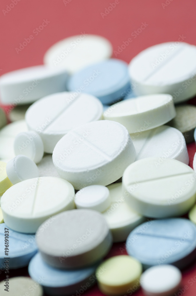 Round multicolored tablets close-up. Soft focus, vertically Round multicolored tablets close-up. Soft focus, vertically