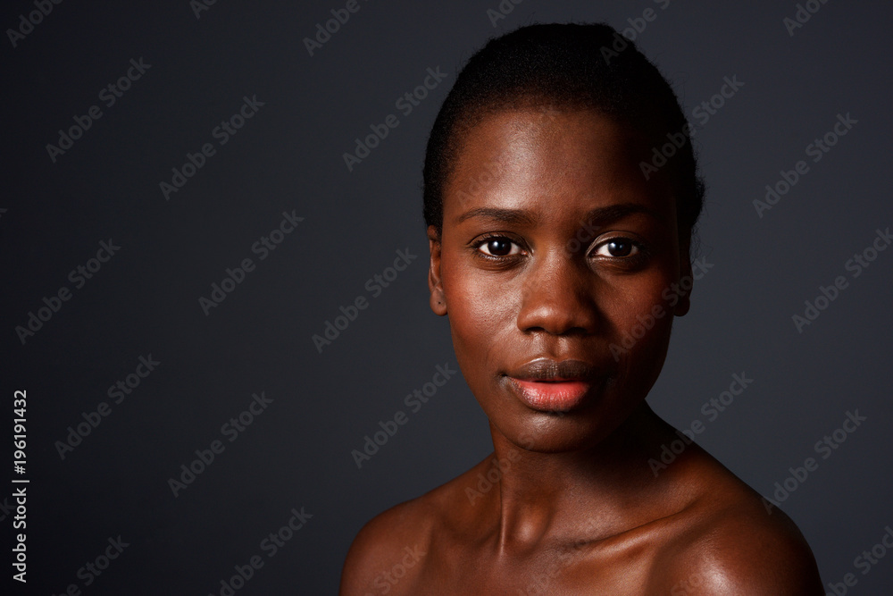 Fototapeta premium Close up beautiful african woman looking at camera with naked shoulders