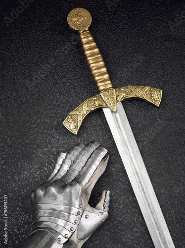 A beautiful ancient sword of the Order of the Knights Templar and an iron knight's glove.