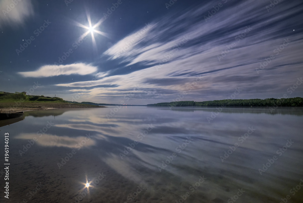 Clouds reflecting in the water under moonlight Clouds reflecting in the water under moonlight