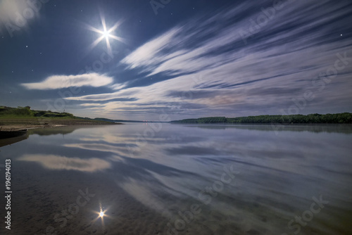 Clouds reflecting in the water under moonlight © Adi