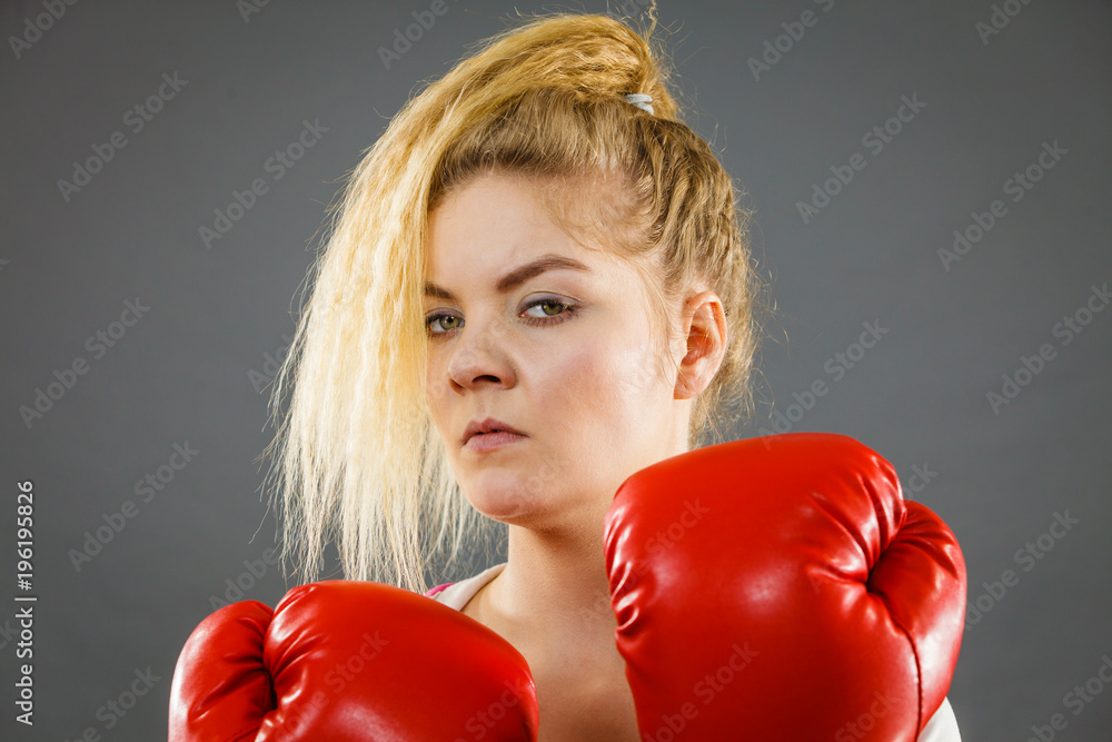 Angry woman wearing boxing gloves Angry woman wearing boxing gloves