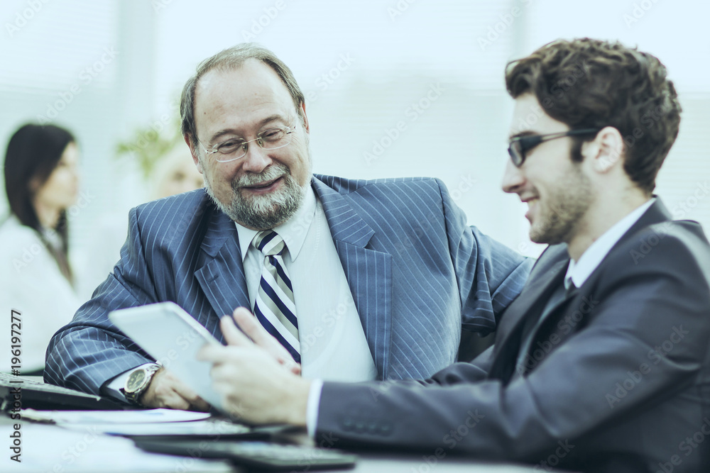 Fototapeta premium members of a business team discussing business documents in the workplace in the office