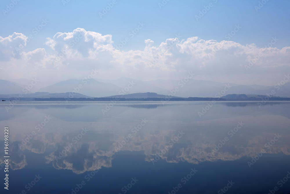 Waterscape of lake with cloudy sky reflection