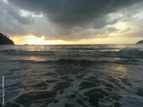 Dark clouds over a beautiful tropical beach with palm trees on Tioman island in Malaysia