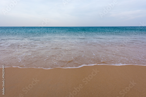 Sand beach with wave and sea with sky. Background