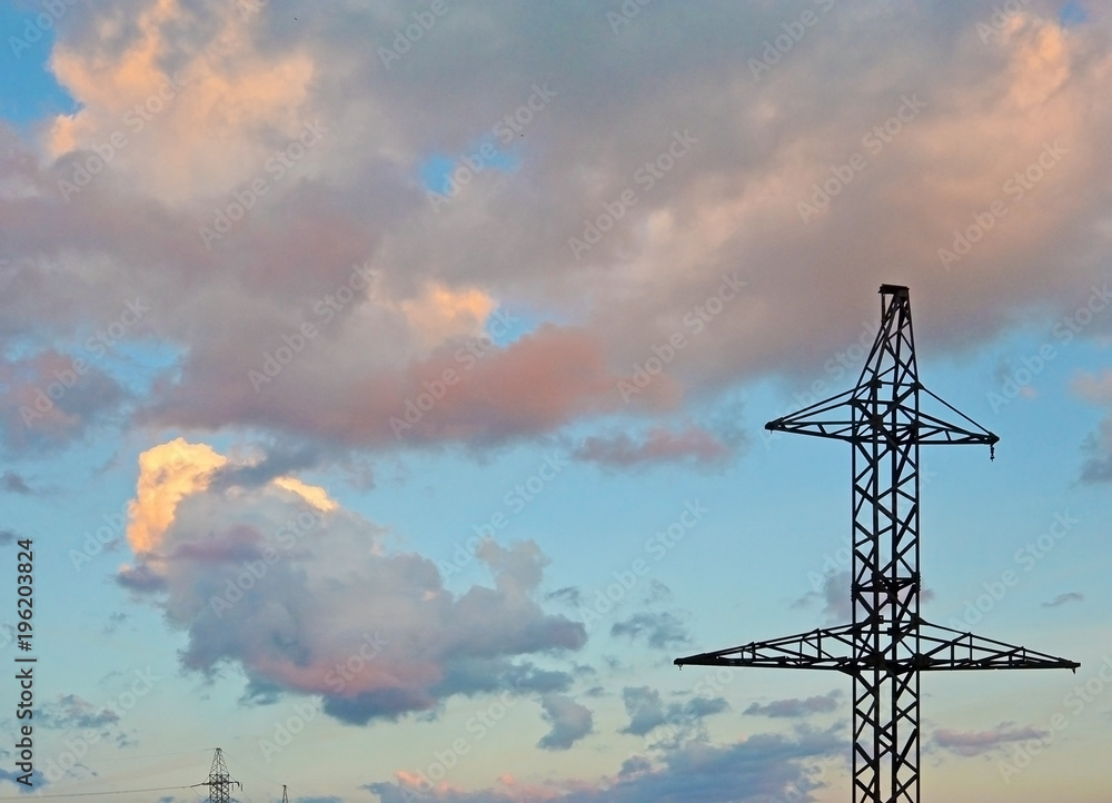 Electricity Pylon - power line transmission tower of the sunset. Beautiful cloudy sky Electricity Pylon - power line transmission tower of the sunset. Beautiful cloudy sky