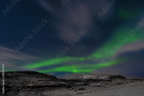 Northern Lights over snow capped mountains in southern Iceland