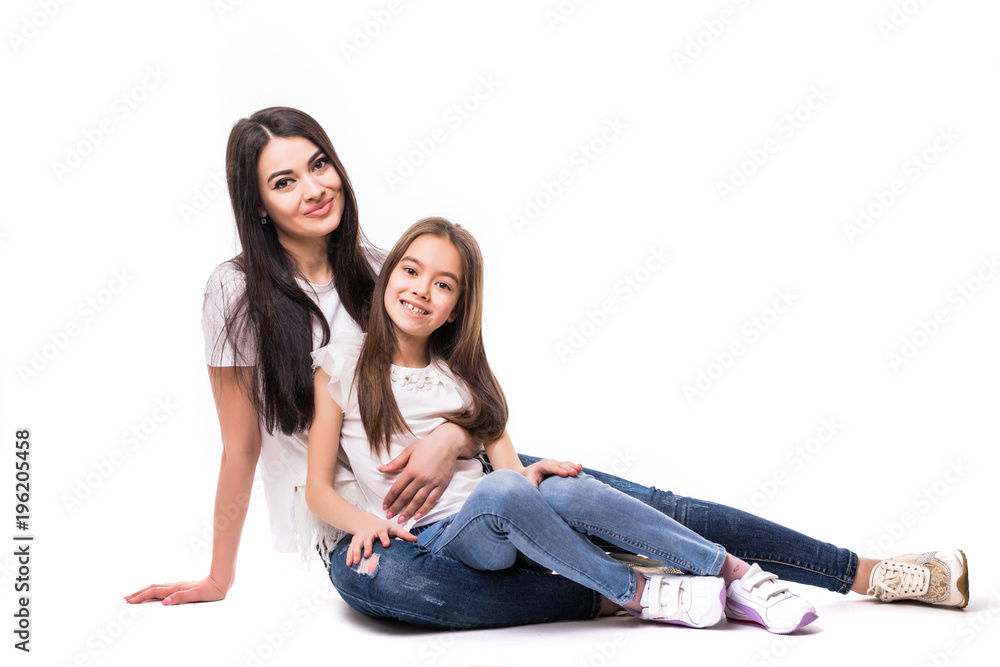 Two sister younger and older lying on the floor on white background Two sister younger and older lying on the floor on white background