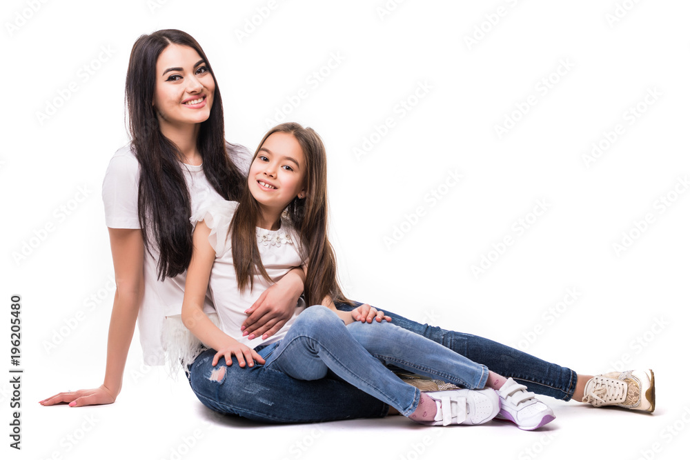 Portrait of happy white mother and young daughter lying on the floor isolated on white background. Happy family people concept. Portrait of happy white mother and young daughter lying on the floor isolated on white background. Happy family people concept.