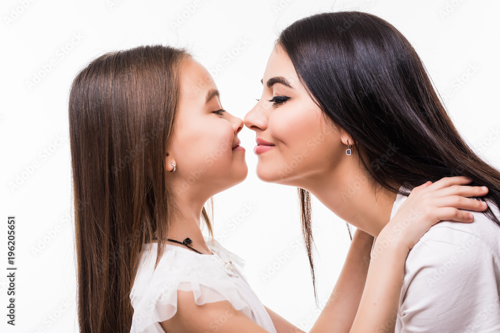 Portrait of happy mother and daughter isolated on white background. Daughter kissing mother. Happy family. Happy mother's day. Mothers day card. Portrait of happy mother and daughter isolated on white background. Daughter kissing mother. Happy family. Happy mother's day. Mothers day card.