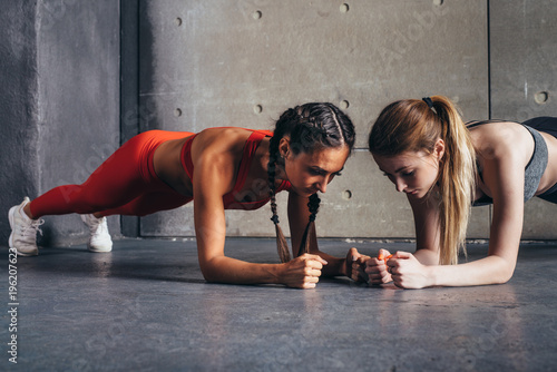 Two fit women doing plank exercise Fitness sport workout