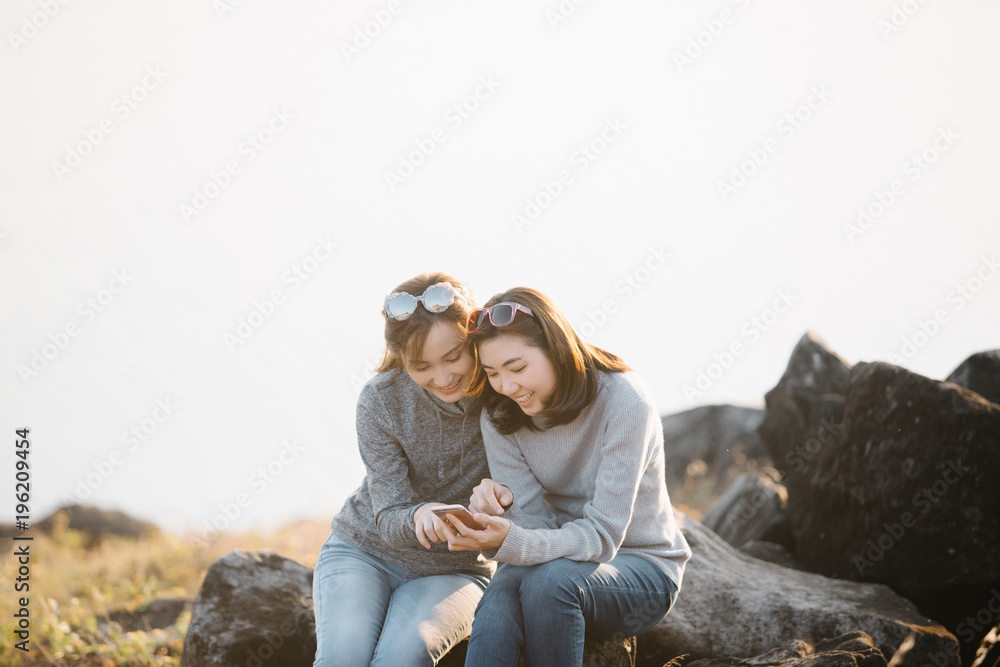 young pretty woman posing in the park with phone, outdoor portrait, hipster girls