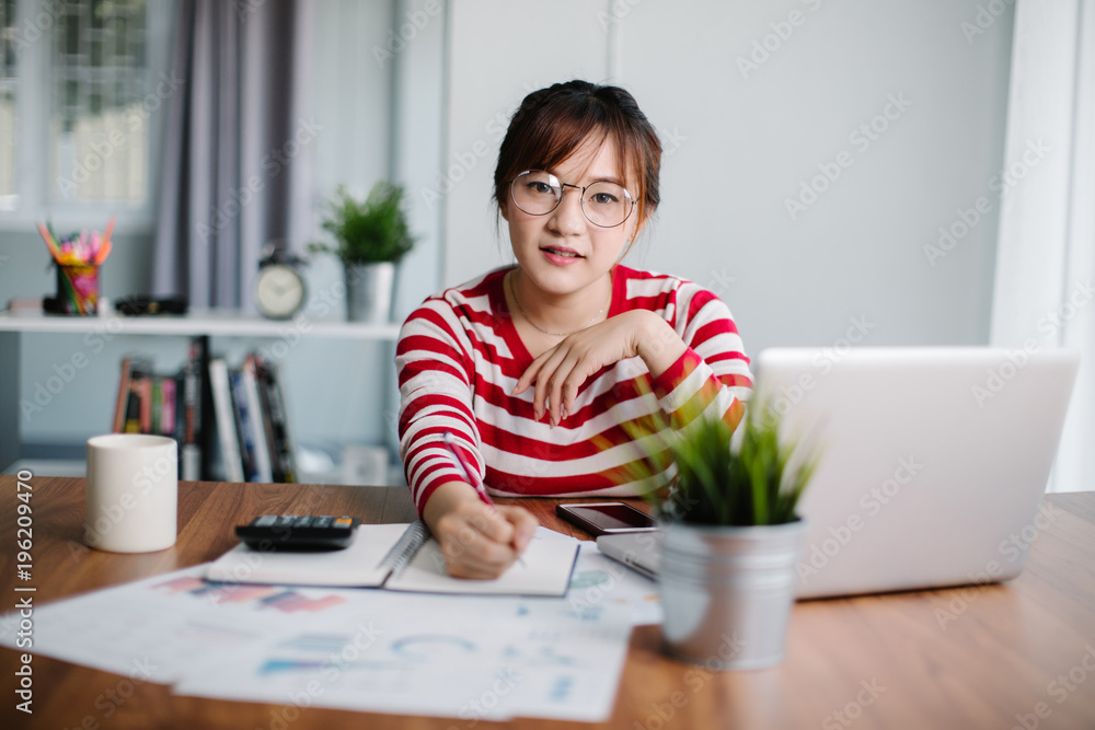 Businesswoman working online using laptop in office Businesswoman working online using laptop in office