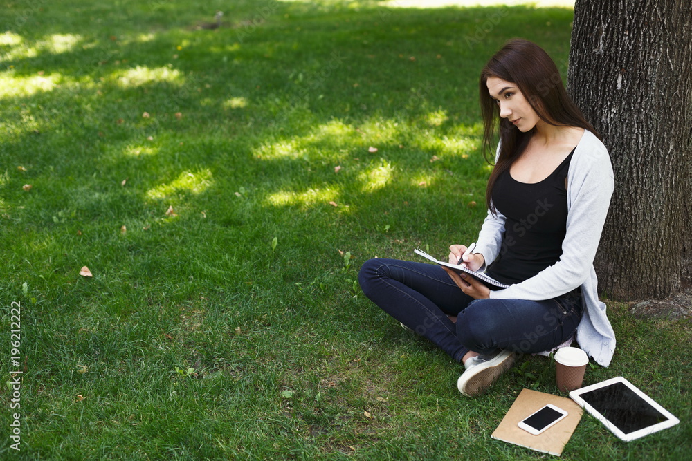 Young woman reading book in park Young woman reading book in park