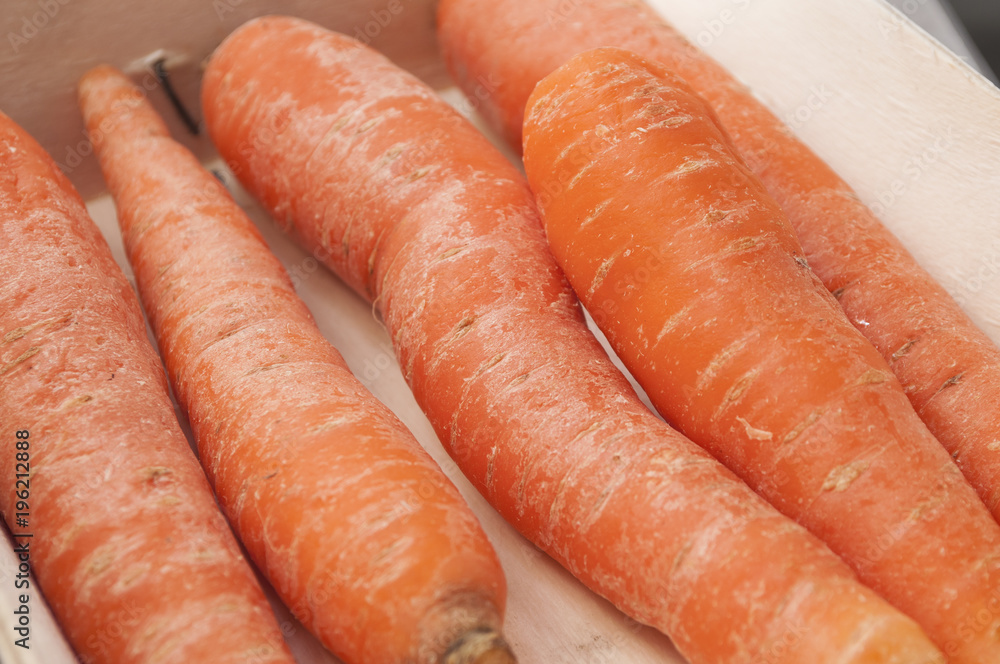 closeup of raw carrots in wooden basket closeup of raw carrots in wooden basket