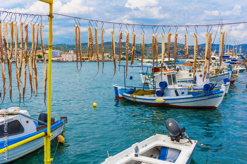 Octapuses hangind under the sun in order to dry at the harbor of Gythio in Peloponnese Greece photo