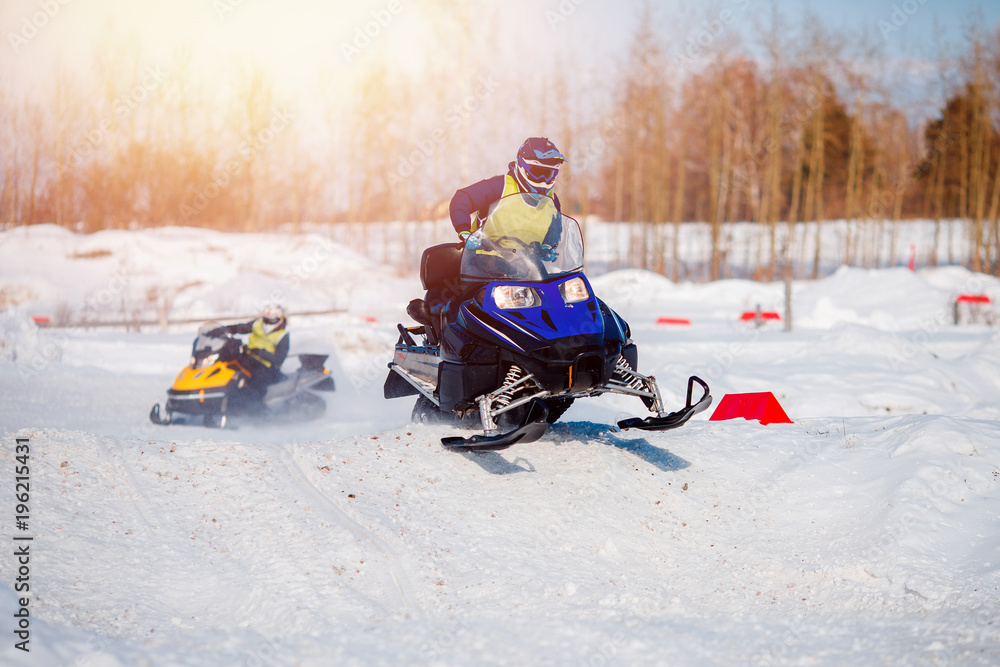 Snowmobile. Snowmobile team of friends races in snow. Concept winter sports, racers. Snowmobile. Snowmobile team of friends races in snow. Concept winter sports, racers.