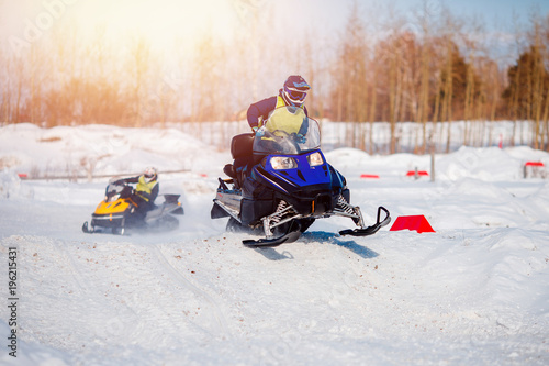 Snowmobile. Snowmobile team of friends races in snow. Concept winter sports, racers.