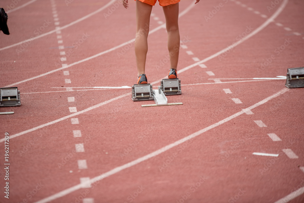 Athletics people running on red running track