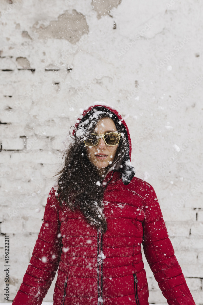 Winter snowy portrait of a young woman wearing red jacket Winter snowy portrait of a young woman wearing red jacket
