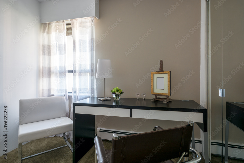 Modern bright home office interior with leather chair and desk.