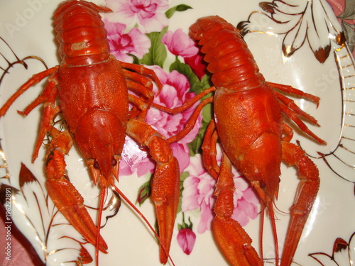 Many cancers boiled large, red on the table. Eyes, long antennae, and oral cavity with additional processes and a pair of claws.