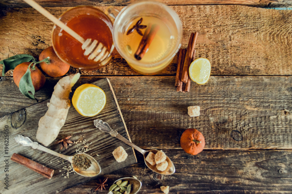 Vitamin medicinal tea with lemon and honey, ginger and spices on wooden background . The concept of spring beriberi and colds. Vitamin medicinal tea with lemon and honey, ginger and spices on wooden background . The concept of spring beriberi and colds.