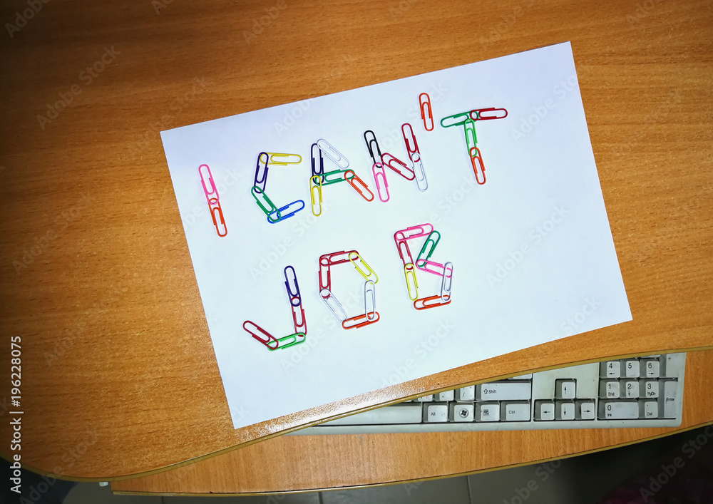 Concept. In the office on the desktop on a white sheet of paper lined with paper clips words. I can't work. Concept. In the office on the desktop on a white sheet of paper lined with paper clips words. I can't work.