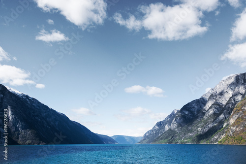 Minimalistic norwegian landscape with mountains  water and clouds