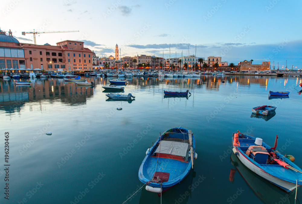 Evening view of marina with different boats. Old Town district. Bari, Italy.