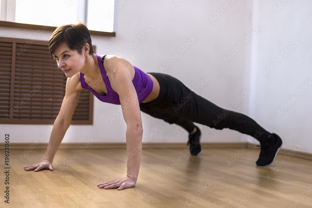 a woman at the gym doing exercises a woman at the gym doing exercises