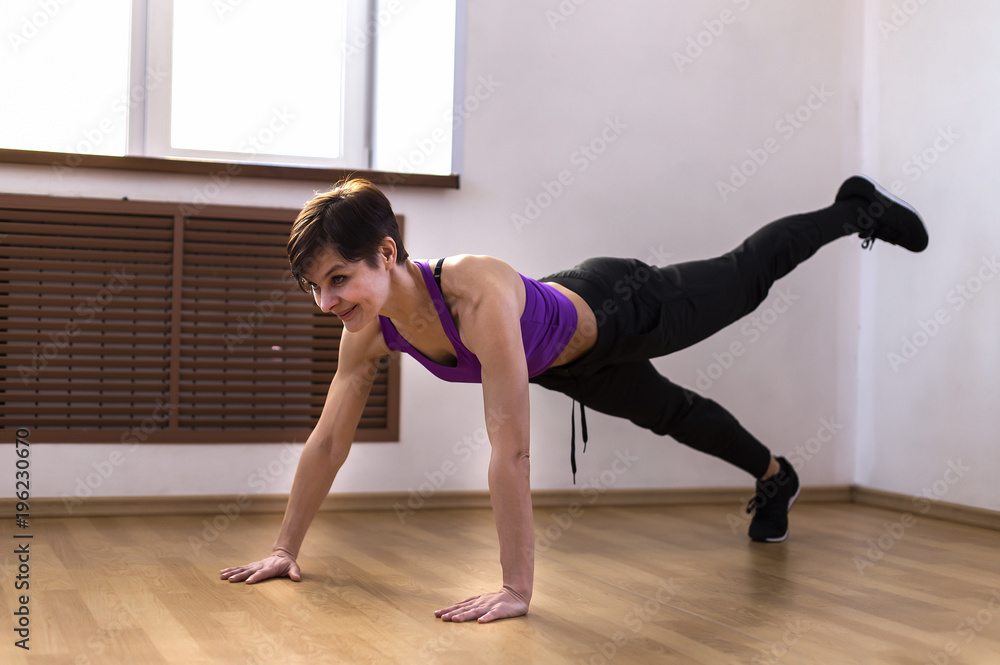 a woman at the gym doing exercises a woman at the gym doing exercises