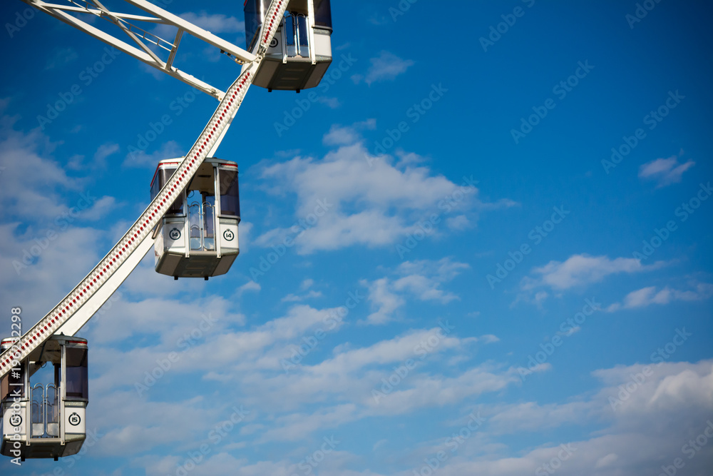 Horizontal View of a White Ferris Wheel on Partially Cloudy Sky Background. Copy Space. Bari, South of Italy
