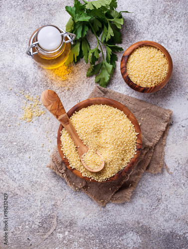 Couscous grain in wooden bowl 
