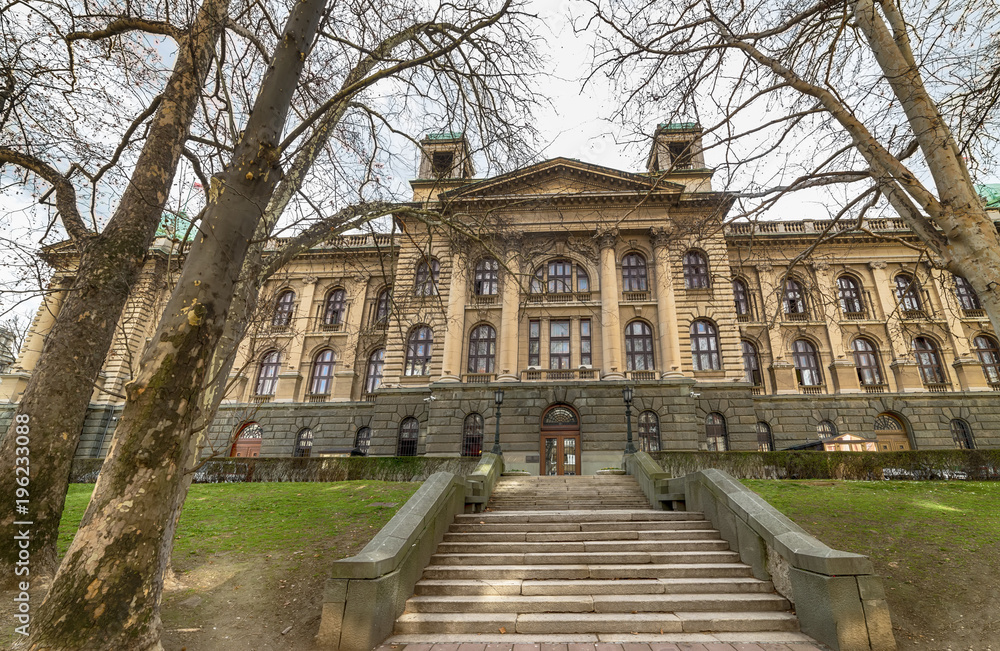 Belgrade, Serbia- Marth 12, 2018: Parliament of the Republic of Serbia in Belgrade. The building of the National Assembly, originally the House of Commons, began to be built in 1907, as a representati Belgrade, Serbia- Marth 12, 2018: Parliament of the Republic of Serbia in Belgrade. The building of the National Assembly, originally the House of Commons, began to be built in 1907, as a representati