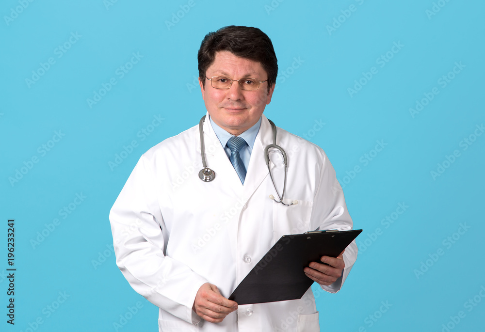 Portrait of middle aged doctor on a blue background. Portrait of middle aged doctor on a blue background.