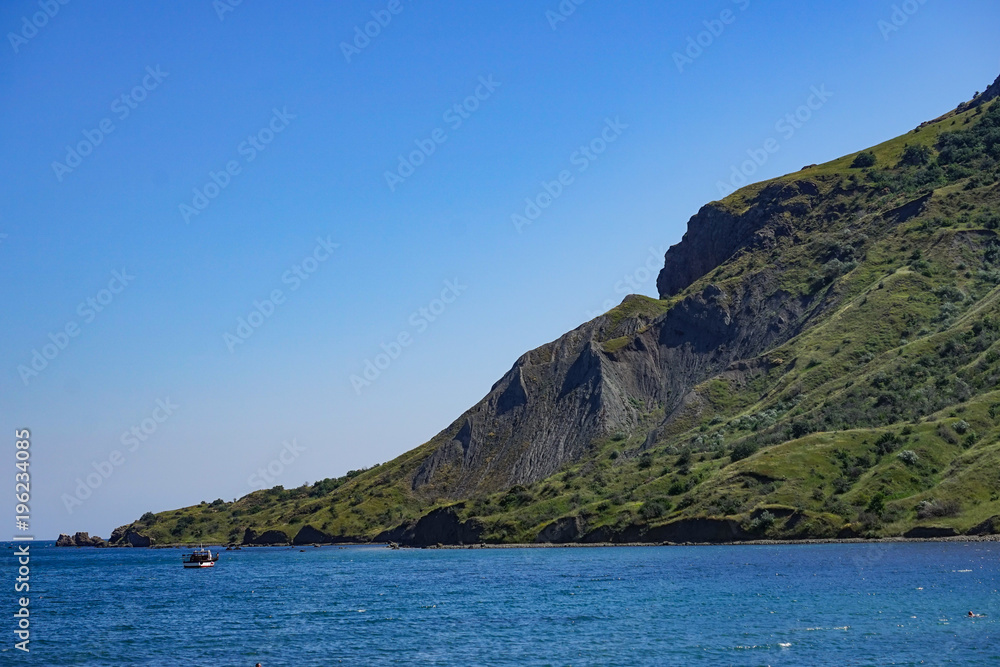 Seascape with a view of the coastline and the calm blue sea. Seascape with a view of the coastline and the calm blue sea.