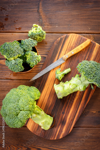 Fresh organic broccoli, cutted on kitchen board. photo