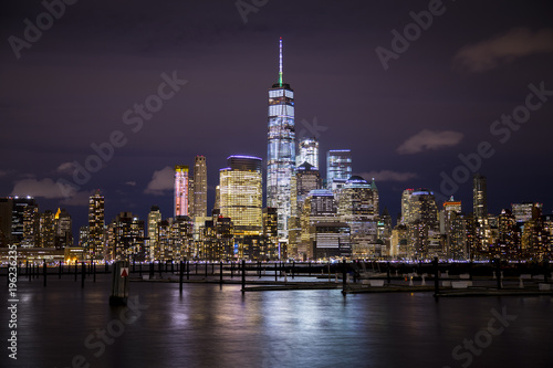 The lights of Lower Manhattan and the World Trade Center reflect off the water of the Hudson River, as seen from Hoboken, New Jersey. © Chris