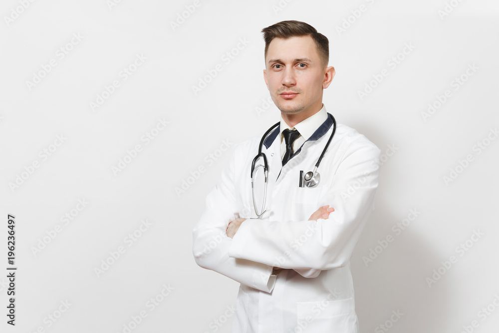 Serious confident experienced handsome young doctor man isolated on white background. Male doctor in medical uniform, stethoscope holding hands folded. Healthcare personnel, health, medicine concept. Serious confident experienced handsome young doctor man isolated on white background. Male doctor in medical uniform, stethoscope holding hands folded. Healthcare personnel, health, medicine concept.