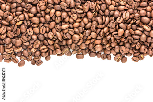 Grains of coffee scattered on the top of the photo. Roasted coffee beans close-up.