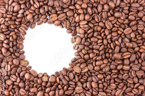 Coffee grains scattered over the surface. Roasted coffee beans close-up. A round white trail on the side is for the text.
