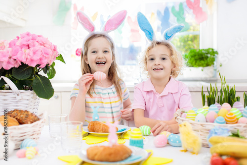 Easter egg hunt. Kids with bunny ears and basket.