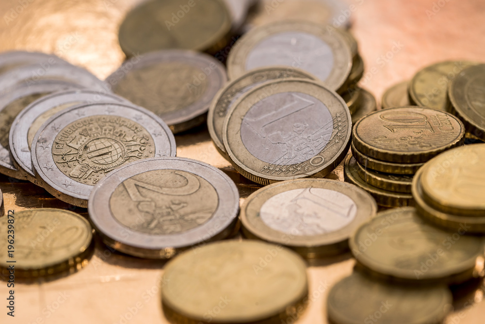 many euro coin isolated on gold close up many euro coin isolated on gold close up