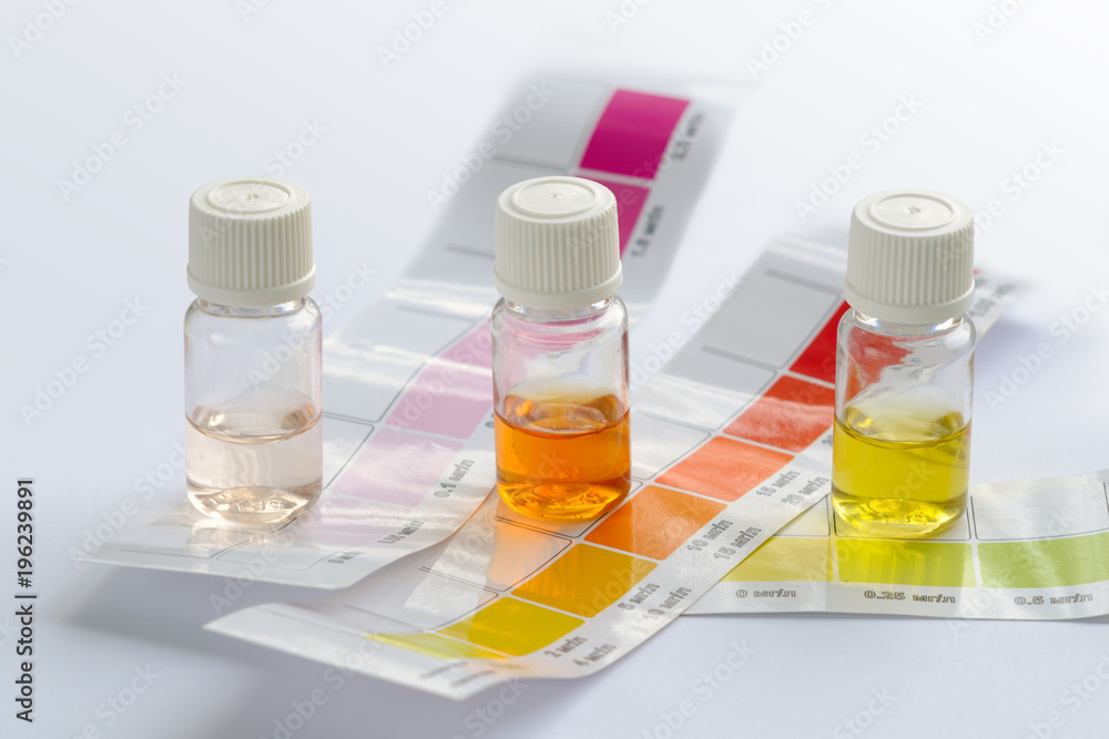 Water quality testing. Three vials with different colored liquids and color scales to determine water characteristics at home Water quality testing. Three vials with different colored liquids and color scales to determine water characteristics at home