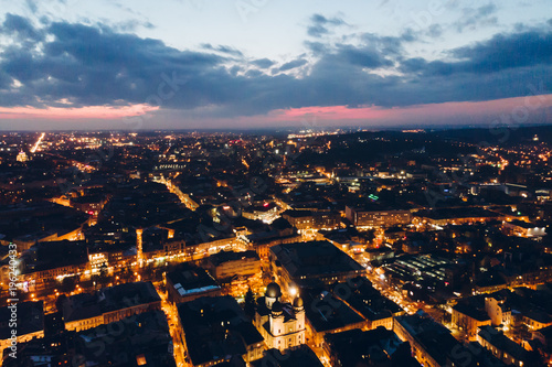 panoramic view of old european city on twilight with red sky. bird's eye view. © phpetrunina14