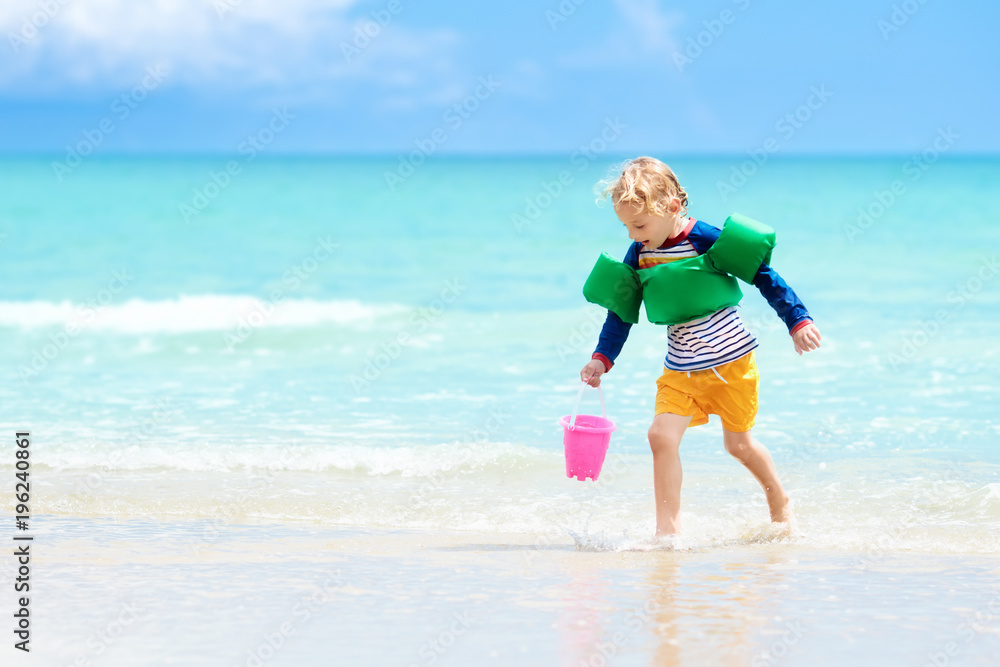 Kids play on tropical beach. Sand and water toy. Kids play on tropical beach. Sand and water toy.