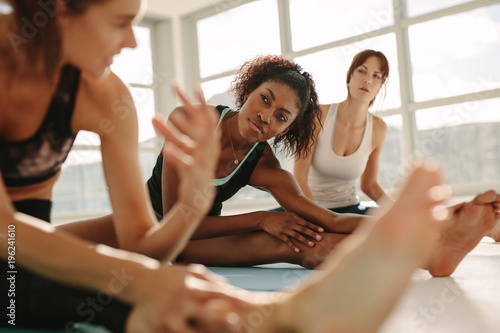 Women during yoga class break at gym